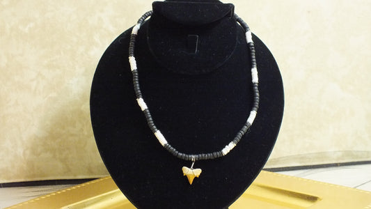 Vintage Black, White and Silver tone puka shell necklace with sharks tooth
